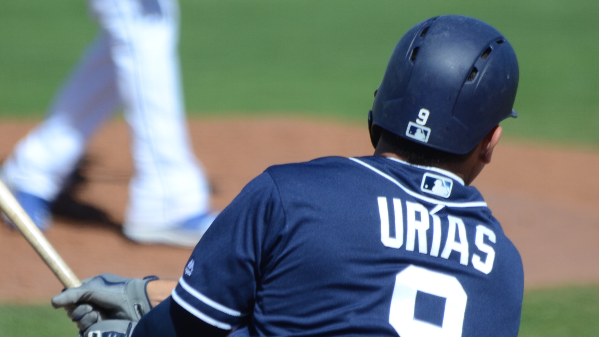 Luis Urias swings during a Spring Training game